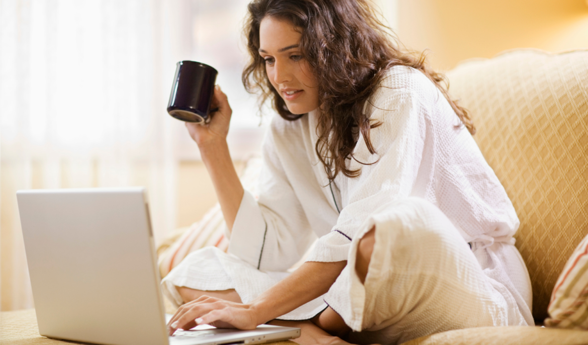 Holistic practitioner working calm at computer with cup of tea
